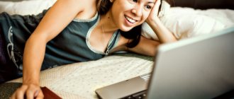 girl smiling looking at laptop